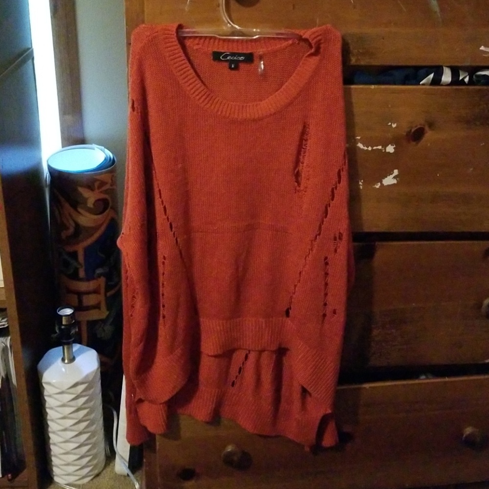 Orange sweater with pre-made holes
